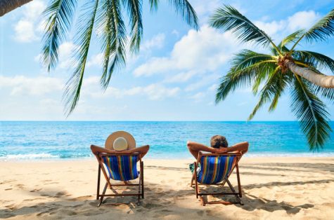 Couple relax on the beach enjoy beautiful sea on the tropical island. Summer beach vacation concept (Getty Images)